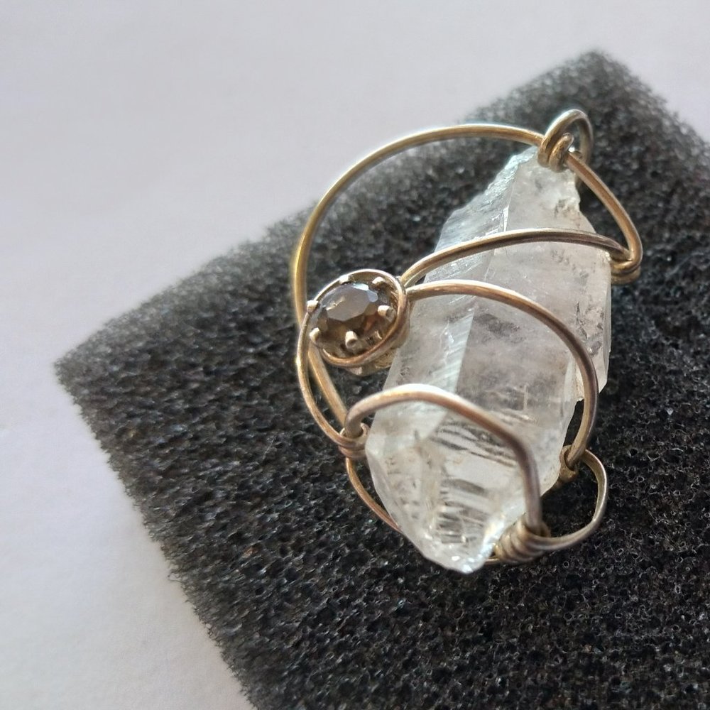 Clear crystal and yellow topaz wire wrapped silver tone pendant.